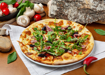 Italian pizza with duck and arugula on wooden background