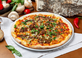 Italian pizza with beef and pork on wooden background