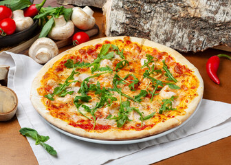Italian pizza with seafood and arugula on wooden background