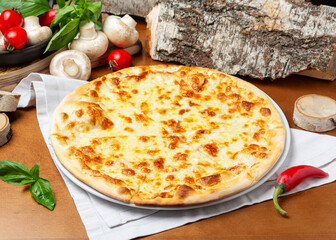 Italian four cheese pizza on wooden background