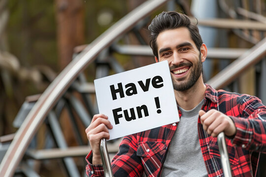 Have fun concept image with a young man having fun in a rollercoaster ride with a sign with written words Have Fun