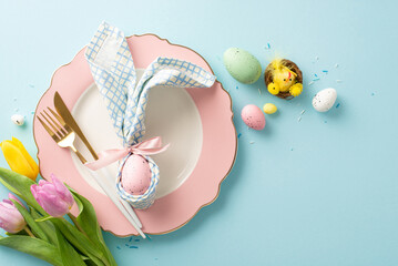 Easter enchantment: top view bunny ears napkin, cutlery, tiny chicken in nest, bunch of tulips,...