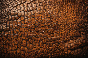 The texture of tanned brown crocodile leather. Leather background. Accessories and material for sewing clothes, bags and shoes made of genuine leather