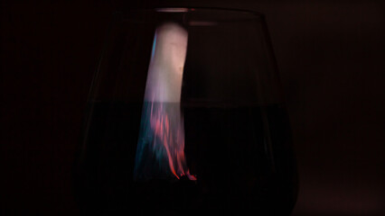 Glass of red wine in a romantically dark room