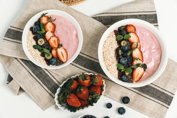 Presented by fruits putting yogurt toppings with strawberry, berry, oats, raisins and chia seed...