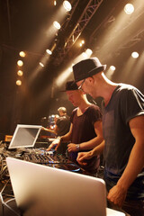Electric, music and dj at stage for performance with sound board and laptop for production in...