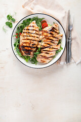 Roasted chicken breast, fillet and fresh vegetable salad.
