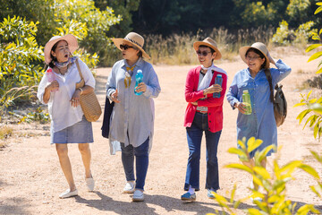 Group of Asian retirement women traveling, hiking, walking together in park, senior pensioner friends spend time exercise trekking outdoor, elderly tourist recreation relationship lifestyle day trip