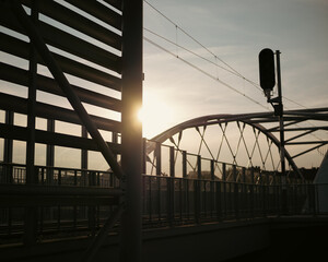A sunset on a railway bridge