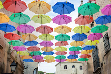 Fototapeta na wymiar Background of colorful umbrellas decorated on a street 