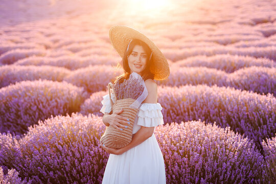 Young girl with a basket of lavender flowers in a lavender.Lavender field