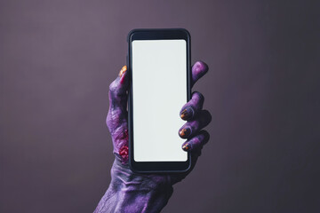 Creepy halloween monster zombie hand holding a mobile phone with a blank screen