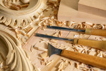 Woodworker Tools Wooden Background. Chisels with wood shavings. Carpenter furniture maker tools on the workbench. - obrazy, fototapety, plakaty