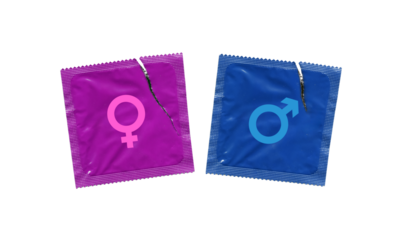 male and female gender signs on blue and pink torn condom wrappers