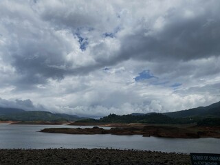 Sky full of beautiful clouds with mountains and river view in Banasura Sagar Dam in Wayanad