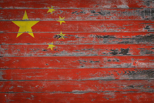 The national flag of China is painted on uneven wooden  boards. Country symbol.
