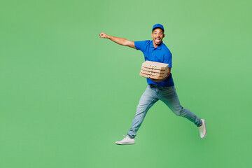 Fototapeta na wymiar Delivery employee man wears blue cap t-shirt uniform workwear work as dealer courier jump high hold stack of pizza in flatbox do super hero gesture isolated on plain green background Service concept.