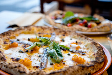 Experience street food by tasting freshly baked pizza made in Naples in multiple flavors and various types