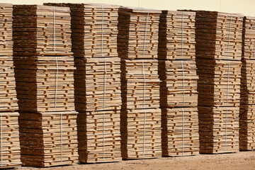 Cut and stacked pieces of wood. Industrial sawmill. Manufacture material