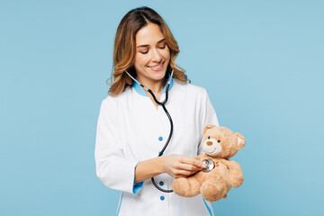 Female doctor woman wears white medical gown suit work in hospital clinic office hold teddy bear...