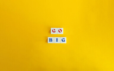 Go Big Phrase on Block Letter Tiles on Yellow Background. Minimalist Aesthetics.