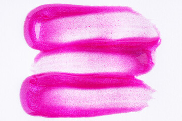 Purple swatch of lip gloss, cosmetic product stroke or paint, macro. Swatches of violet lipgloss or paint on white paper background.