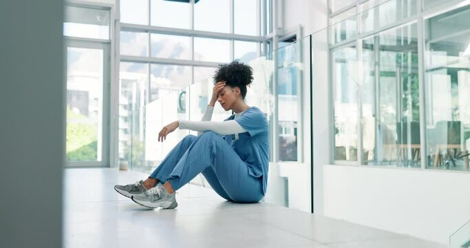 Nurse, stress and woman with depression in hospital for fail, mistake and frustrated at healthcare challenge. Doctor, floor and sad medical professional in crisis, headache and thinking of anxiety