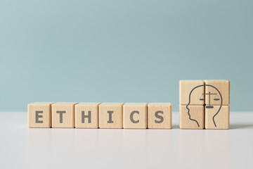 For ethics business  concept.  Ethics text and sign inside a head icon on wooden cubes block on...