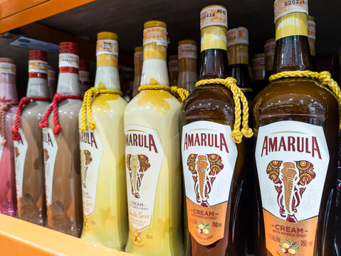 Shelves stocked with Amarula cream liqueurs, showcasing different flavors in a retail store setting.