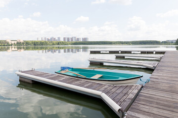 Fototapeta na wymiar boat station by the lake, summer day, smooth water surface, russia