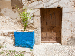 Old house entrance with blue planter in Bocairente (Valencia, Spain) - 725380524