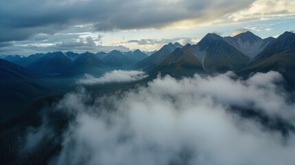 There's an aerial view of a mountain range with volumetric clouds and fog in the foreground.