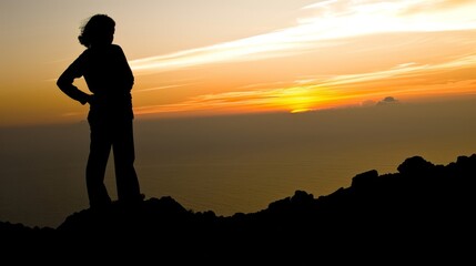 A man and a woman, deeply in love, are standing on top of a mountain at sunset, experiencing a deep sense of spirituality.