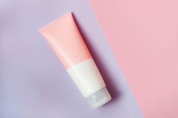 A clean label facial or body cream tube is isolated on a pink background. Beauty product mockup. Wellness packaging. Branding spa. Cream bottle, lotion, mousse, cleanser, shampoo for skincare routine
