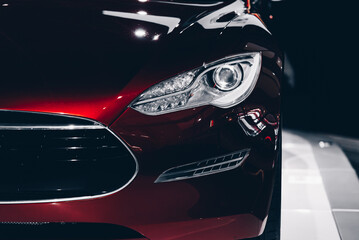 Close up shot of a headlight of a read car © Vladyslav