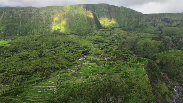 Drone shot of landscape scene of Aldeia da Cuada in Flores island in Azores archipelago at sunset
