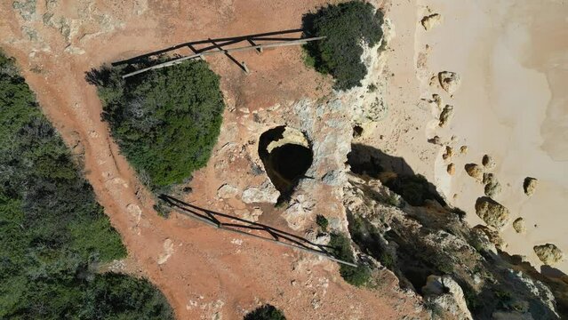 Coastline of Algarve, Portugal. Seven Hanging Valleys Trail with sink hole filmed with 4K drone
