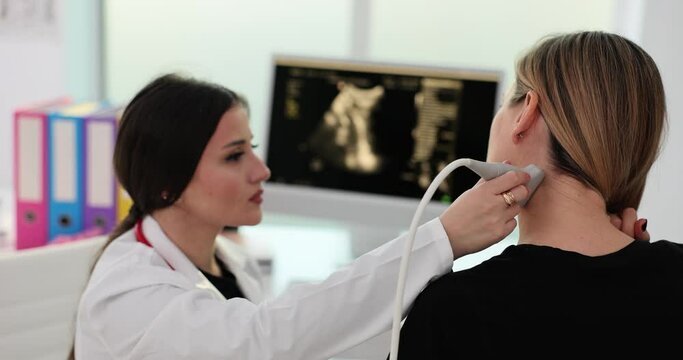 Doctor hands with a probe on a woman neck