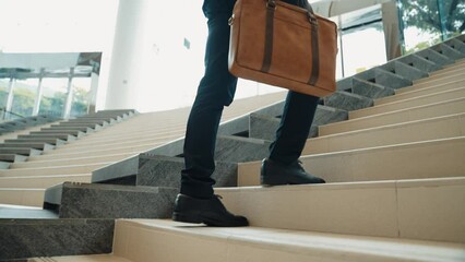 Closeup of business man leg go up the stairs. Successful man going up the stairs while explore a new thing. Represented traveling, getting a promotion, finding a new job, increasing skill. Exultant.