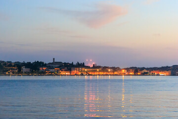 Fototapeta premium The old town of Rovinj with the church of St. Euphemia seen from the sea on a sunny day with blue sky