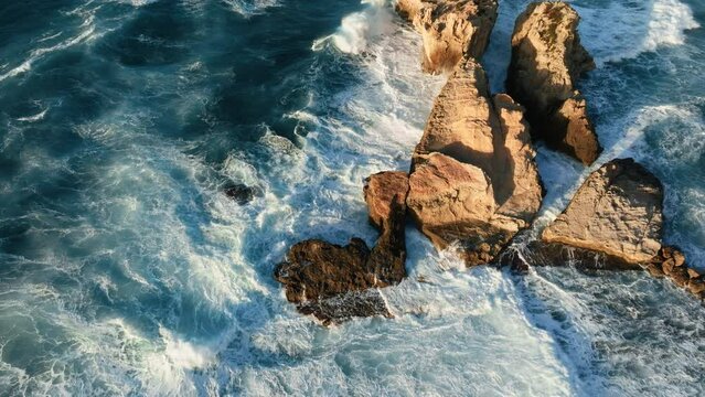 White foam of waves crashing into rocks 