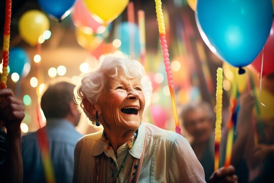 senior lady with glow sticks dancing amongst party balloons
