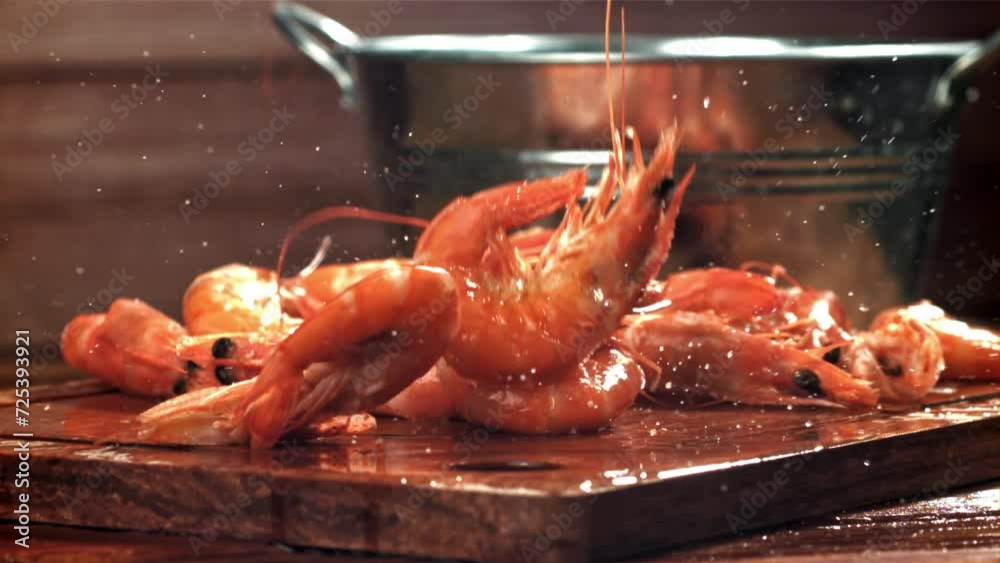 Poster the shrimp falls on a wooden cutting board. filmed on a high-speed camera at 1000 fps. high quality 