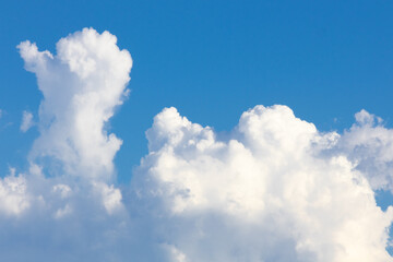 Naklejka na ściany i meble Scenic view of white fluffy clouds in the blue sky