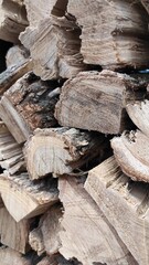 Large pile of stacked chopped firewood, close-up, texture