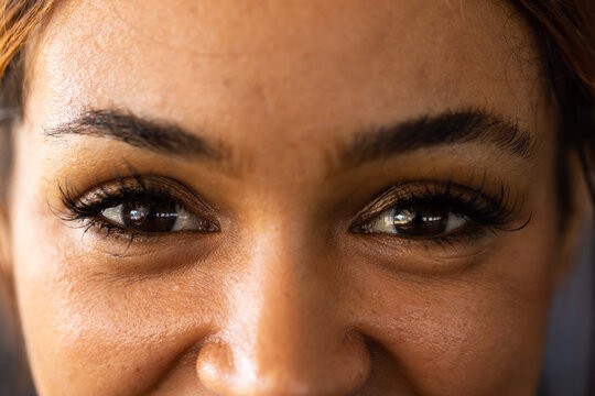 Closeup portrait of confident biracial young woman with black eyes looking at camera in health club