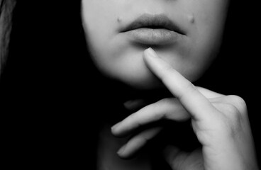 Portrait of a beautiful brunette woman. Natural beauty. Hand and lips close-up.