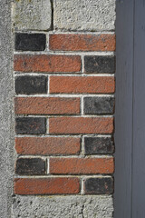 renovation of a wall with cement and exposed bricks