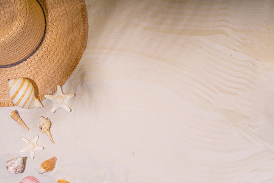 Summer sunny sand background with straw hat