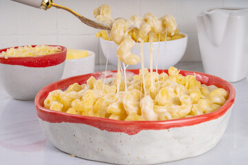 Creamy mac and cheese with ingredients for cooking